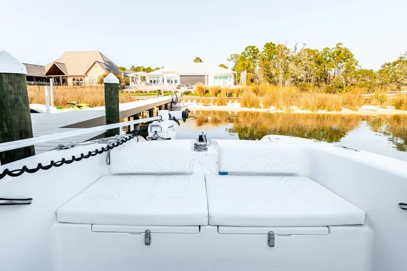 Endless Bs Yacht Photos Pics 2023 Twin Vee 260 GFX CC boat docked by serene waterfront with lush greenery.