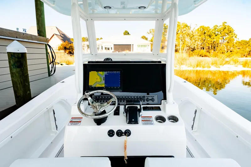 Endless Bs Yacht Photos Pics 2023 Twin Vee 260 GFX CC boat console with steering wheel and navigation display.