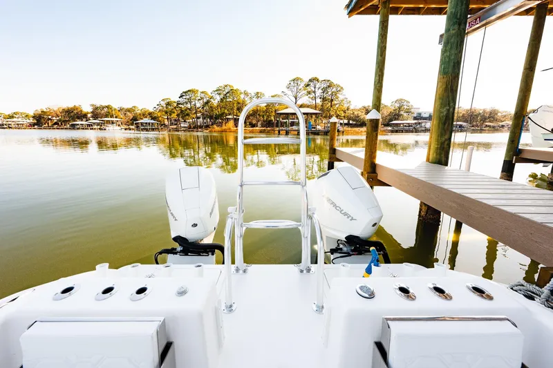Endless Bs Yacht Photos Pics 2023 Twin Vee 260 GFX CC boat docked on calm water with dual Mercury engines.