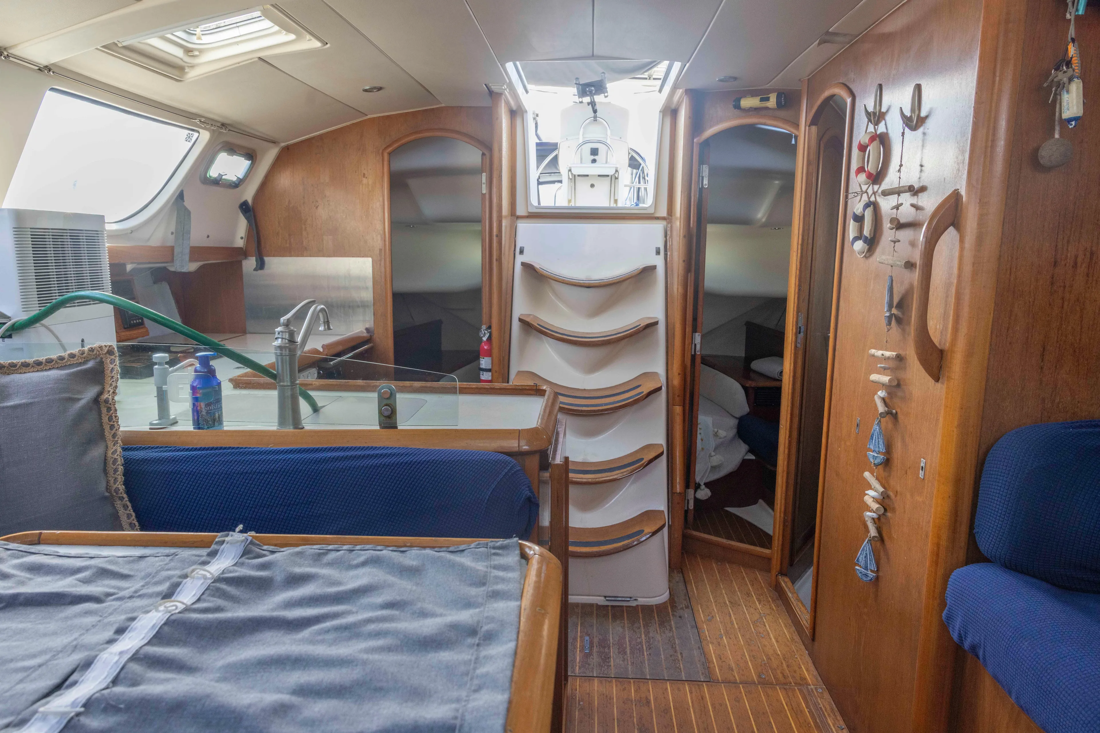 Atlas Yacht Photos Pics Interior of 2001 Jeanneau Sun Odyssey 43 DS sailboat, featuring cozy seating and wooden decor.