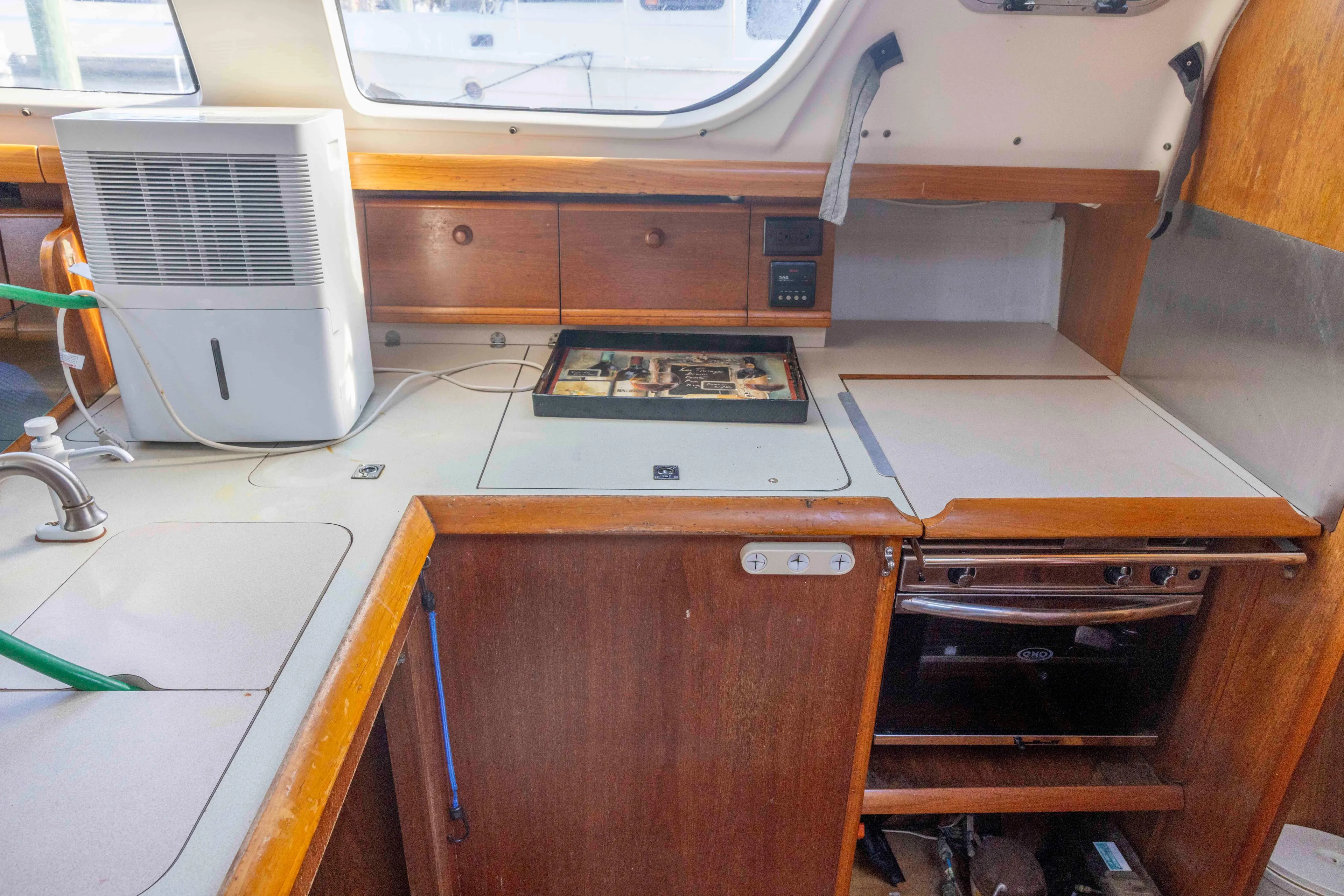 Atlas Yacht Photos Pics Interior of 2001 Jeanneau Sun Odyssey 43 DS yacht kitchen with appliances and wooden cabinetry.