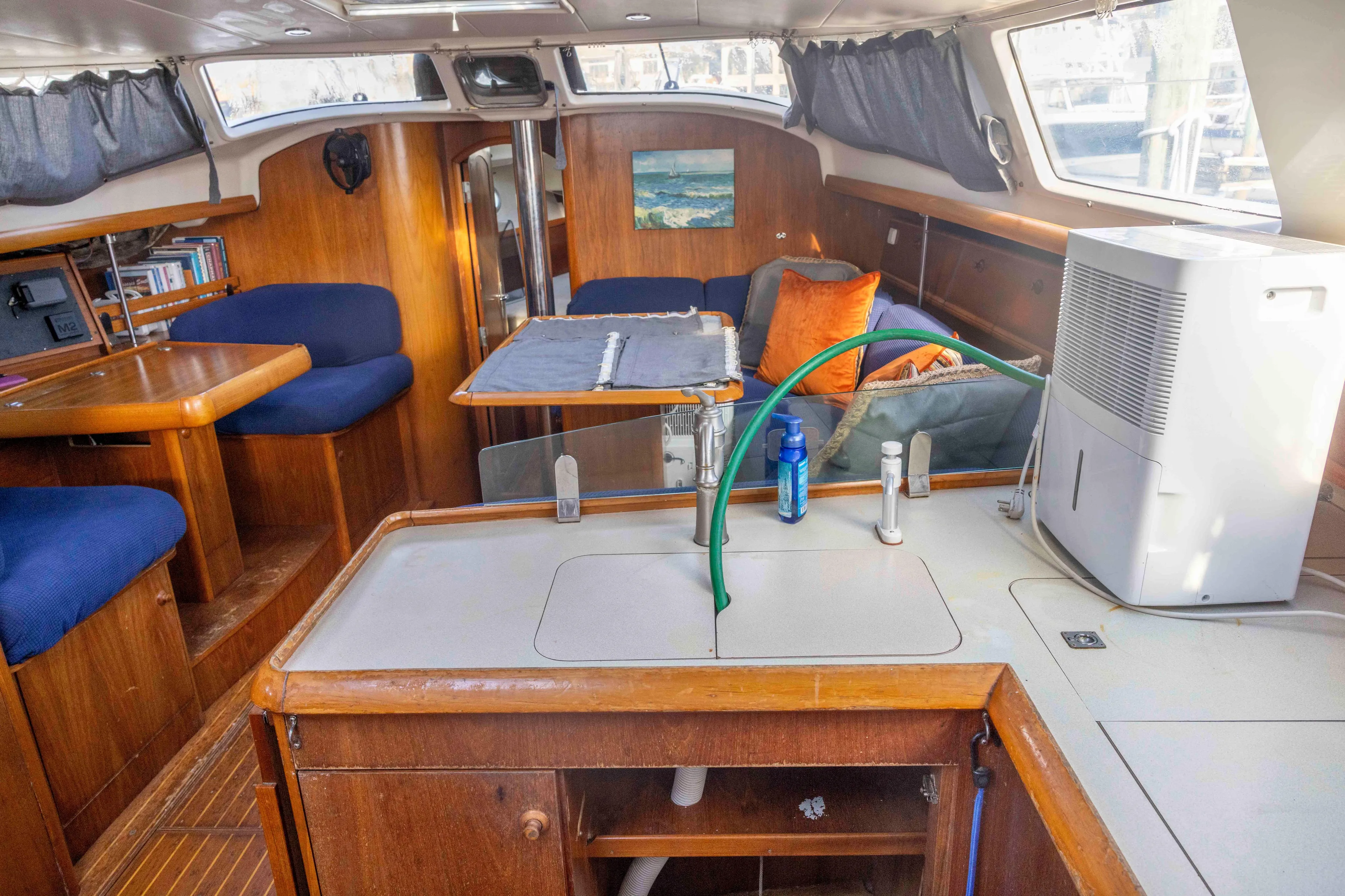 Atlas Yacht Photos Pics Interior of 2001 Jeanneau Sun Odyssey 43 DS sailboat with cozy seating and kitchenette.