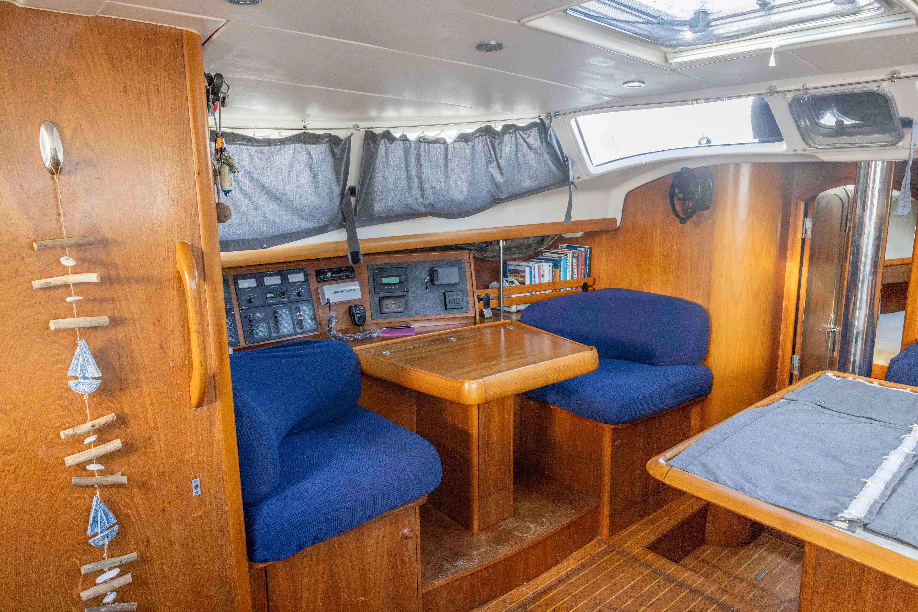 Atlas Yacht Photos Pics Interior of 2001 Jeanneau Sun Odyssey 43 DS sailboat with wooden furnishings and blue seating.