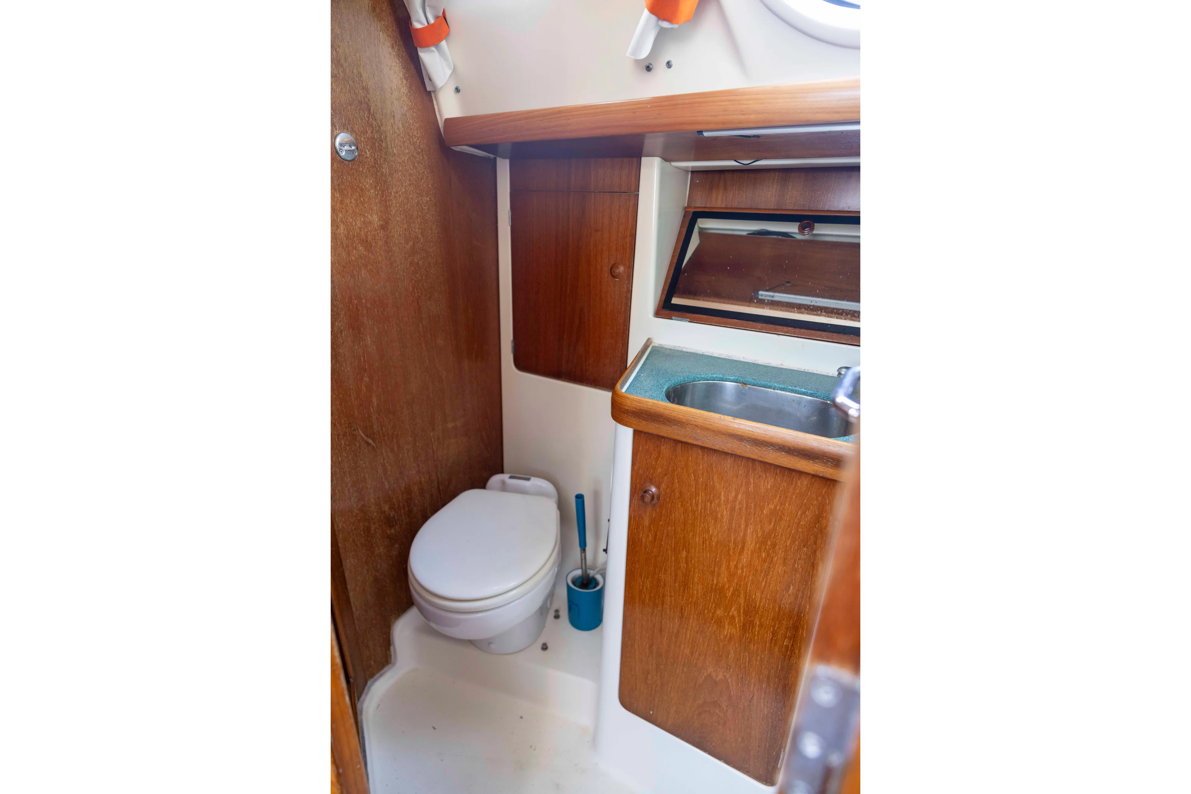 Atlas Yacht Photos Pics 2001 Jeanneau Sun Odyssey 43 DS yacht bathroom with wooden cabinetry and compact sink.