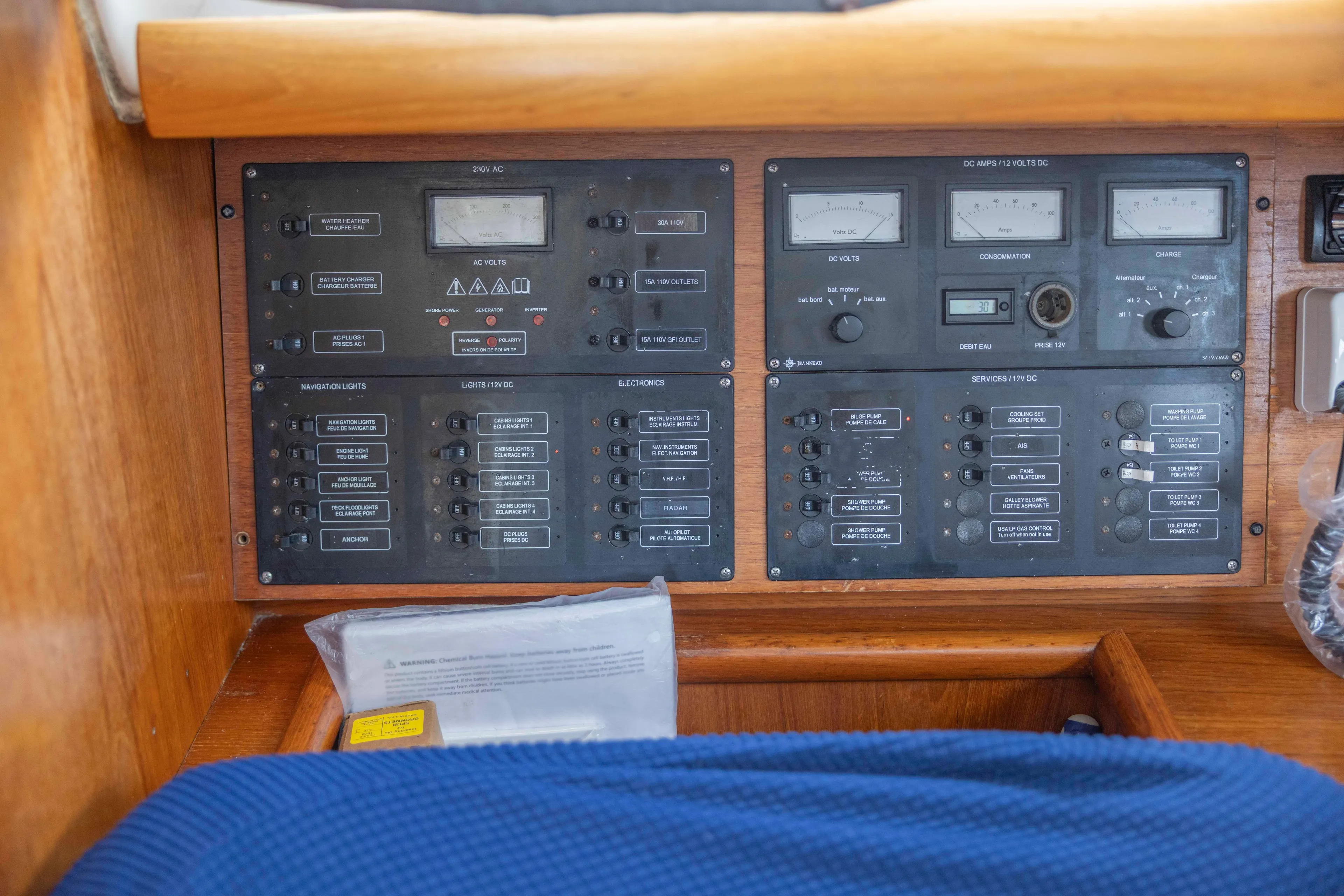 Atlas Yacht Photos Pics Control panel of a 2001 Jeanneau Sun Odyssey 43 DS sailboat, featuring various switches and gauges.