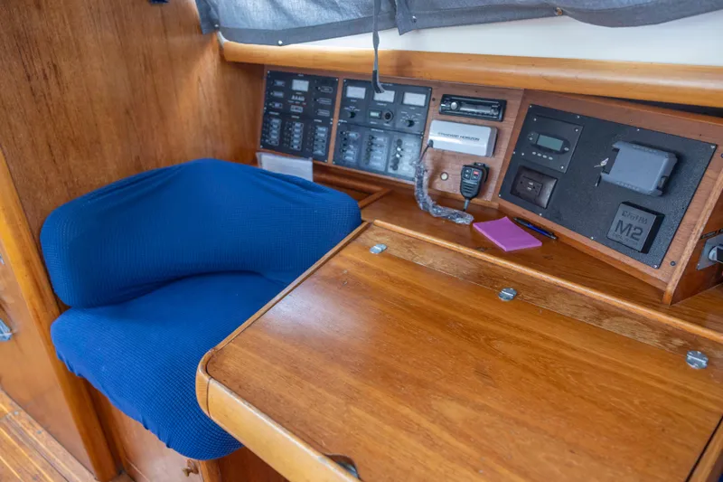 Atlas Yacht Photos Pics Navigation station of 2001 Jeanneau Sun Odyssey 43 DS with blue seat and control panels.