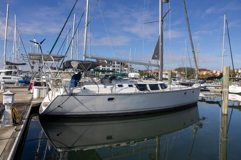 Atlas Yacht Photos Pics 2001 Jeanneau Sun Odyssey 43 DS sailboat docked in a marina under clear skies.
