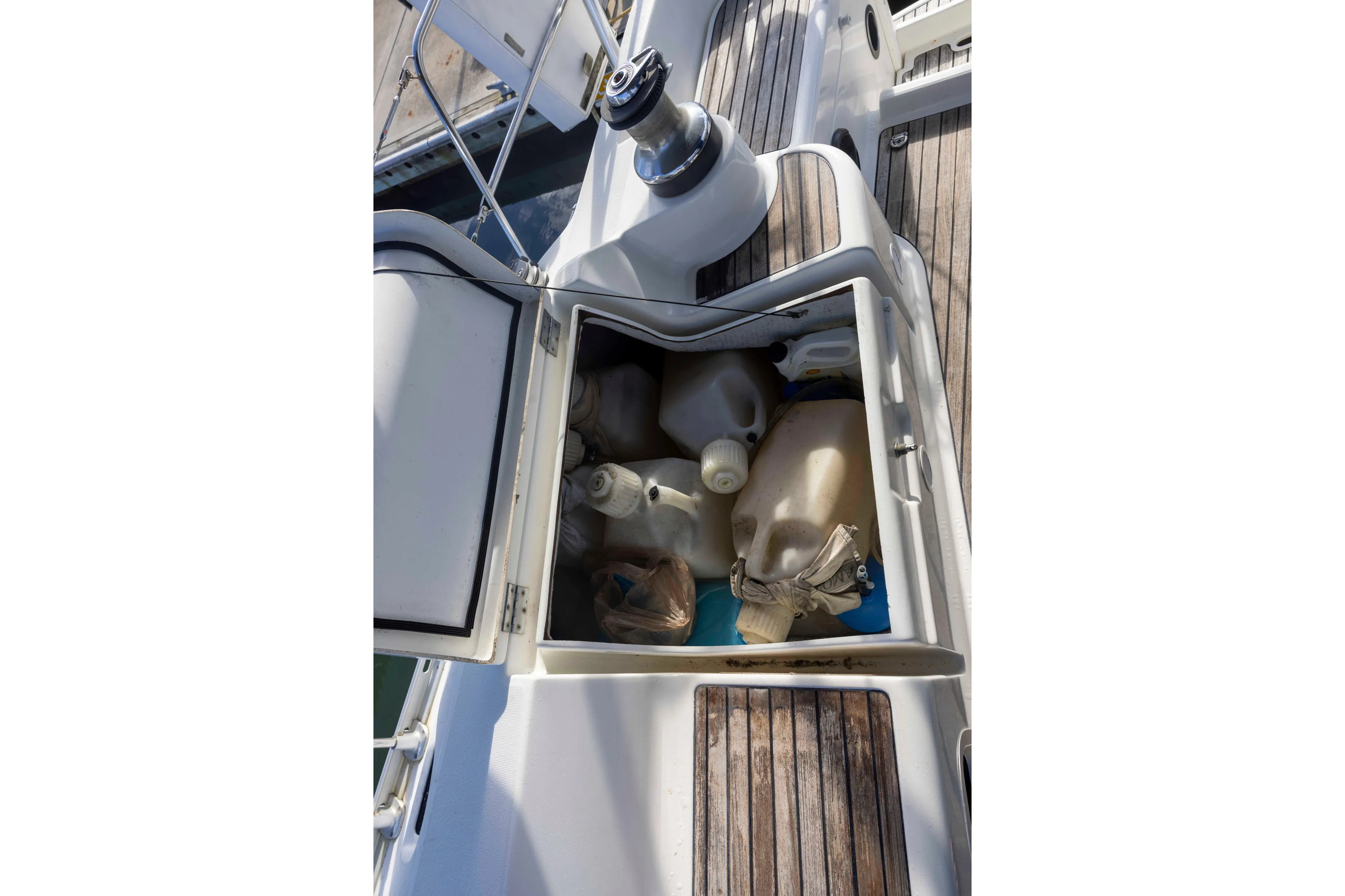 Atlas Yacht Photos Pics Storage compartment on 2001 Jeanneau Sun Odyssey 43 DS sailboat, filled with plastic containers.