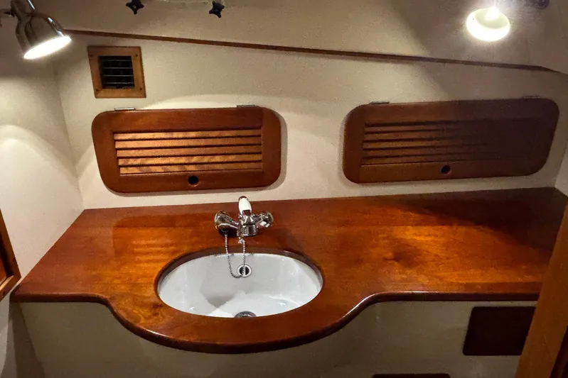 Manitou Yacht Photos Pics 2004 Hinckley 36 Picnic Boat EP interior with wooden sink area and lighting.