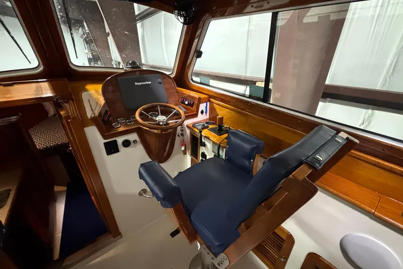 Manitou Yacht Photos Pics Helm of 2004 Hinckley 36 Picnic Boat EP with wooden steering wheel and navigation equipment.