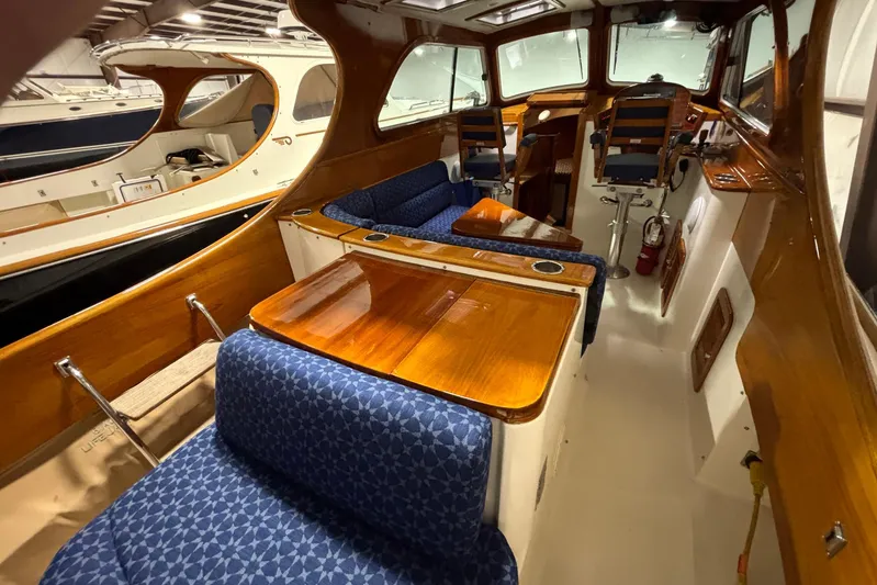 Manitou Yacht Photos Pics 2004 Hinckley 36 Picnic Boat EP interior with wooden finishes and blue patterned seating.