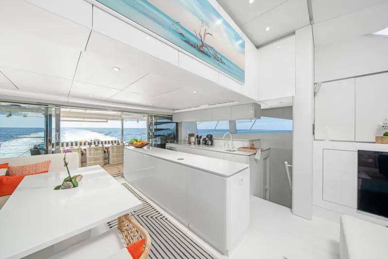 Royal Rita Yacht Photos Pics Luxurious interior of 2016 Sunreef 70 yacht with modern kitchen and ocean view.