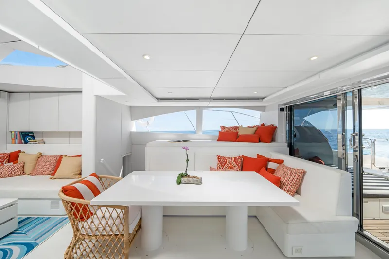 Royal Rita Yacht Photos Pics Luxurious Sunreef 70 yacht interior, featuring modern white and orange decor, 2016 model.