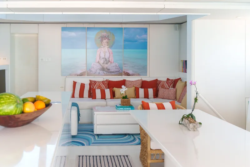 Royal Rita Yacht Photos Pics Luxurious Sunreef 70 yacht interior with modern decor, vibrant cushions, and fruit bowl.