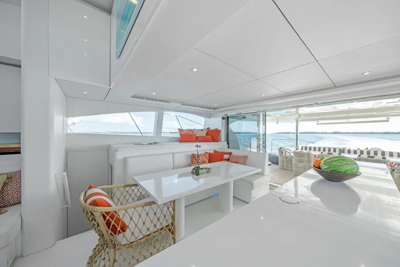 Royal Rita Yacht Photos Pics Luxurious interior of 2016 Sunreef 70 yacht with modern seating and ocean view.
