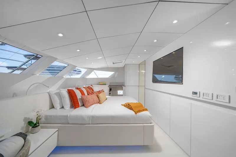 Royal Rita Yacht Photos Pics Luxurious Sunreef 70 yacht bedroom, modern design, 2016 model, with elegant white and orange accents.