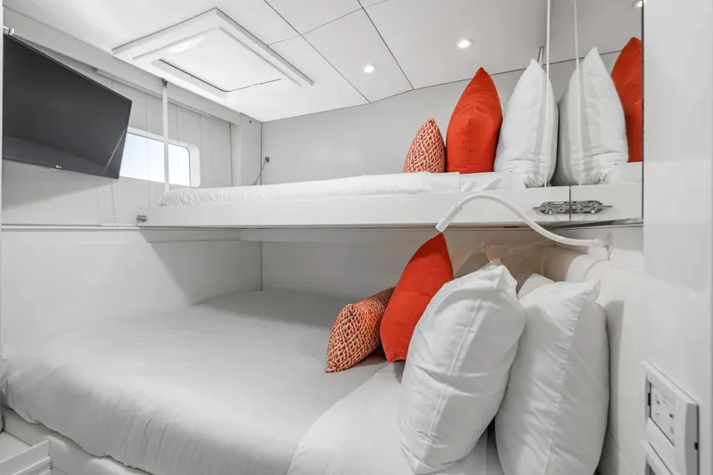Royal Rita Yacht Photos Pics Luxurious Sunreef 70 yacht cabin with modern bunk beds and vibrant orange accents.