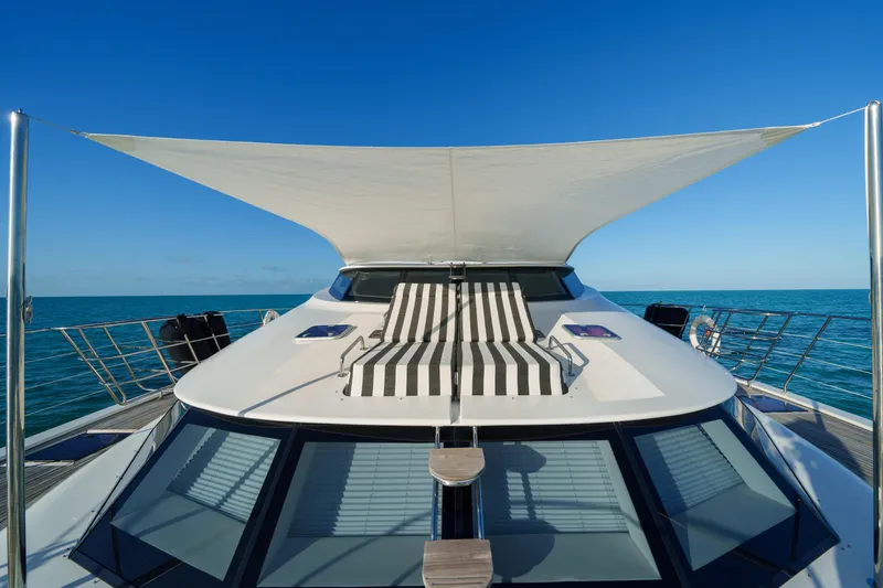 Royal Rita Yacht Photos Pics Luxurious Sunreef 70 yacht deck with sunshade and striped lounge chair, 2016 model.