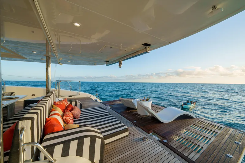 Royal Rita Yacht Photos Pics Luxurious Sunreef 70 yacht deck with striped seating, ocean view, and modern design, 2016 model.