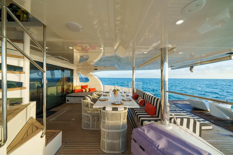 Royal Rita Yacht Photos Pics Luxurious Sunreef 70 yacht deck with dining area, ocean view, and stylish seating, 2016 model.