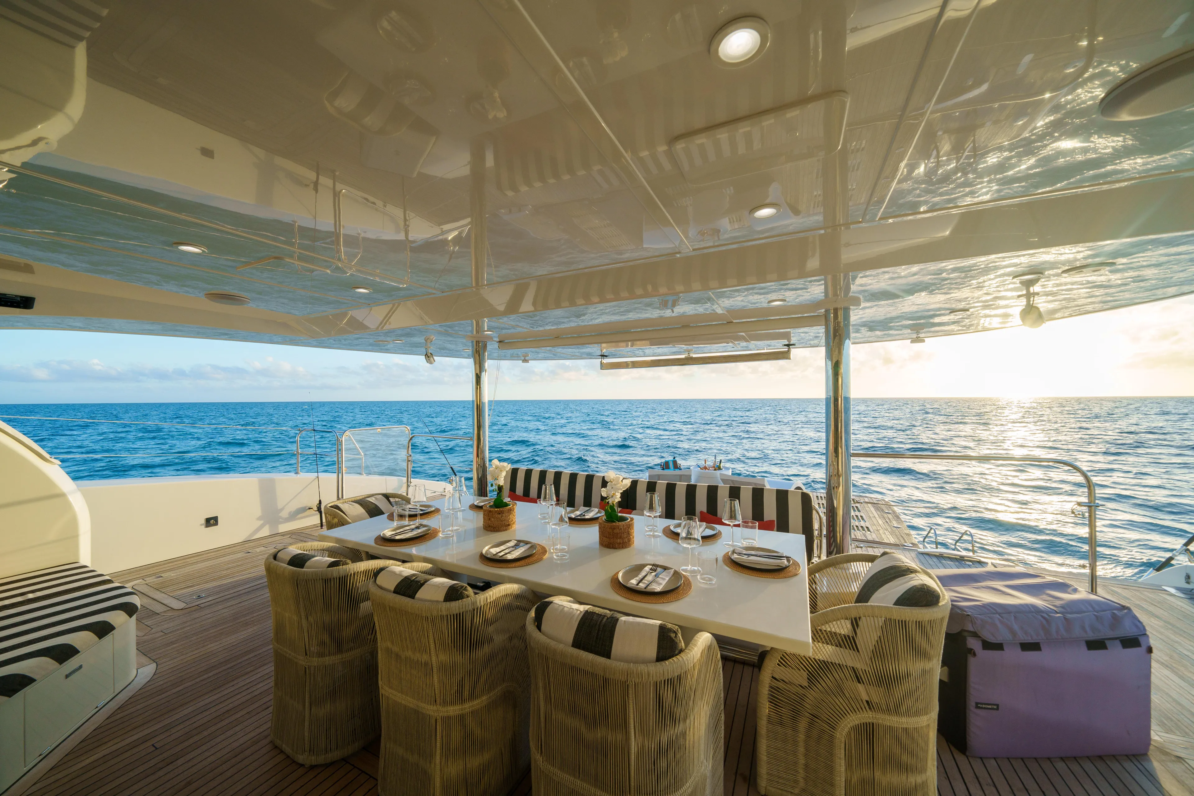 Royal Rita Yacht Photos Pics Luxurious Sunreef 70 yacht deck with dining area, ocean view, and sunset ambiance, 2016 model.