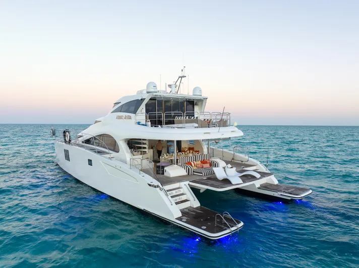 Royal Rita Yacht Photos Pics Luxurious 2016 Sunreef 70 yacht on serene ocean waters at sunset.