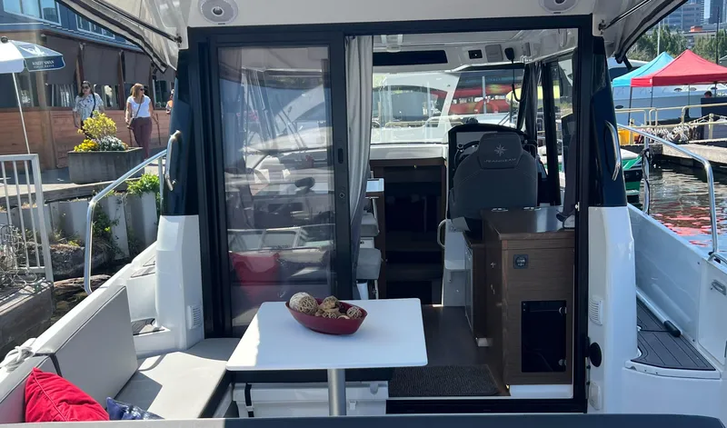  Yacht Photos Pics 2021 Jeanneau 895 boat interior with table and seating area.