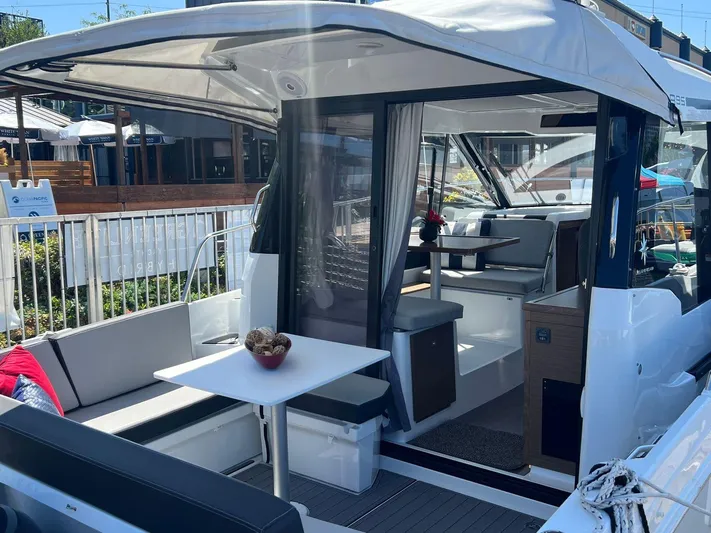  Yacht Photos Pics 2021 Jeanneau 895 boat interior with seating and dining area.