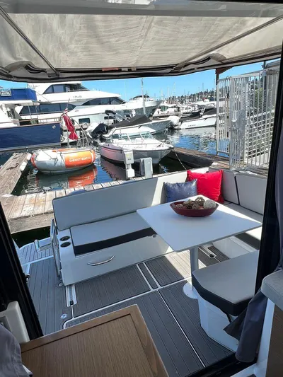  Yacht Photos Pics 2021 Jeanneau 895 boat with outdoor seating area at marina.