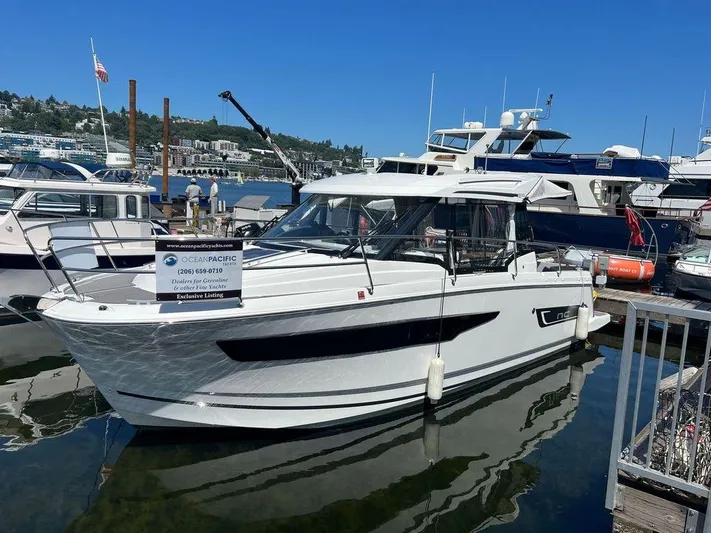  Yacht Photos Pics 2021 Jeanneau 895 boat docked at marina on a sunny day.