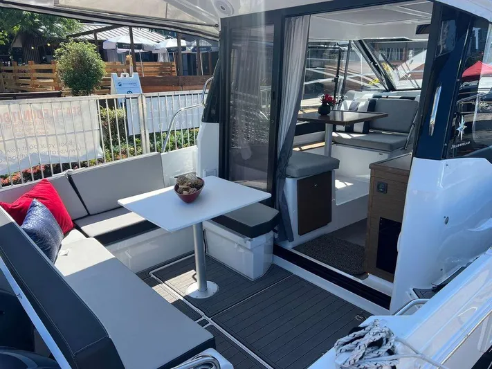  Yacht Photos Pics 2021 Jeanneau 895 boat interior with seating and dining area.