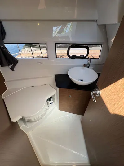  Yacht Photos Pics 2021 Jeanneau 895 boat bathroom with toilet, sink, and window.