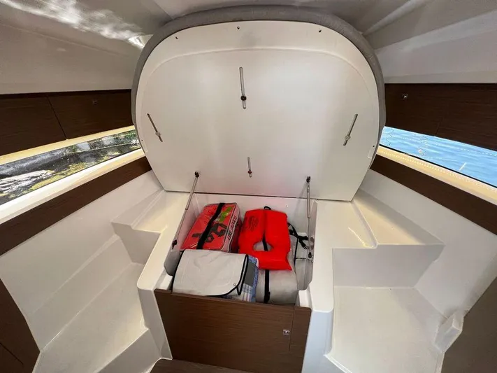  Yacht Photos Pics 2021 Jeanneau 895 boat interior storage compartment with life jackets and gear.