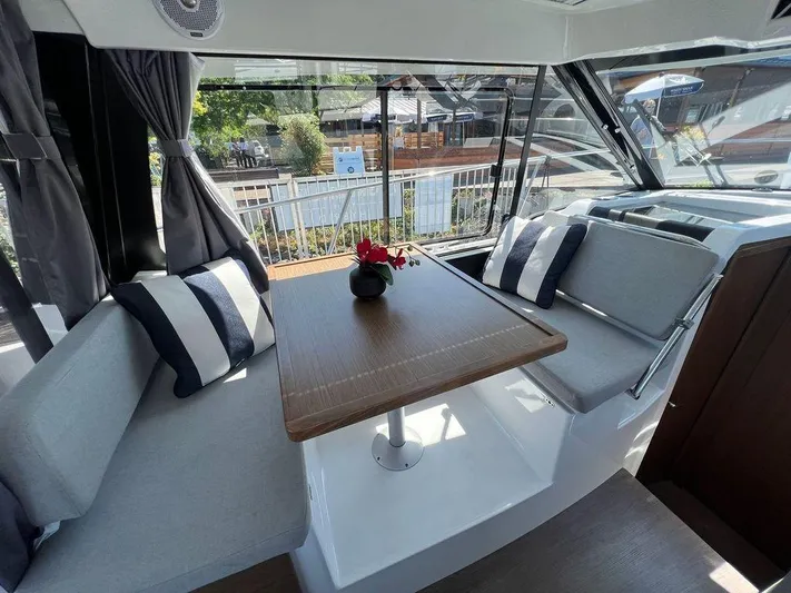  Yacht Photos Pics Interior of 2021 Jeanneau 895 boat with dining area and large windows.