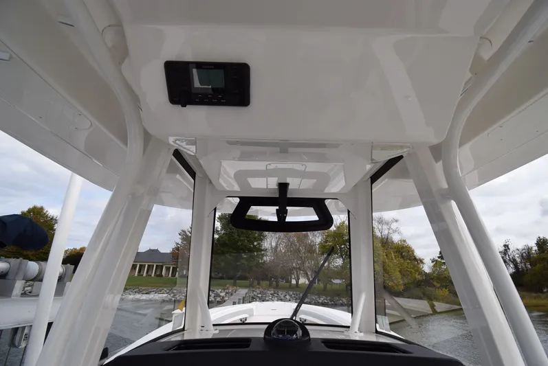 Shore Runner Yacht Photos Pics Interior view of 2021 Regulator 34 boat, showcasing helm and overhead console.