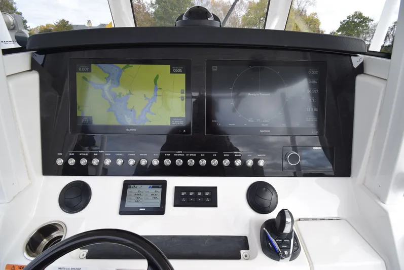 Shore Runner Yacht Photos Pics 2021 Regulator 34 boat dashboard with dual Garmin displays and control panel.