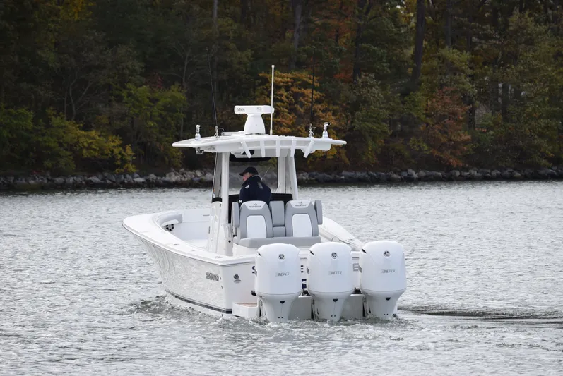 Shore Runner Yacht Photos Pics 2021 Regulator 34 boat with triple engines cruising on a lake.