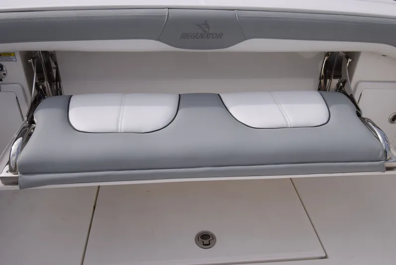 Shore Runner Yacht Photos Pics 2021 Regulator 34 boat with a foldable gray and white cushioned seat.