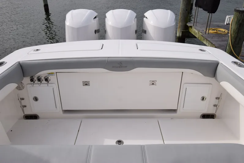 Shore Runner Yacht Photos Pics 2021 Regulator 34 boat stern with triple outboard engines and storage compartments.