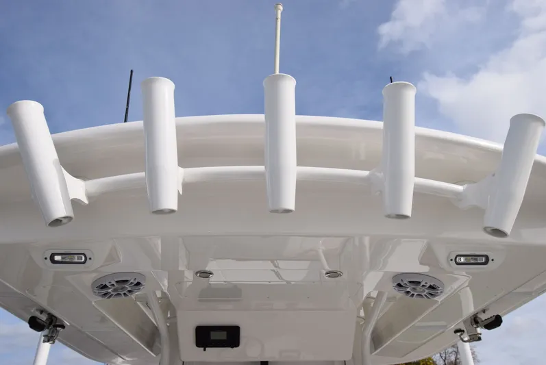 Shore Runner Yacht Photos Pics 2021 Regulator 34 boat with rod holders and speakers under a clear sky.