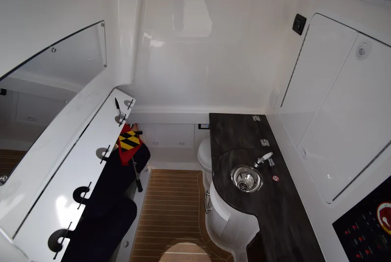 Shore Runner Yacht Photos Pics 2021 Regulator 34 boat interior with compact sink, storage, and seating area.