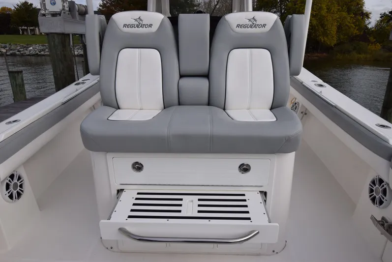 Shore Runner Yacht Photos Pics 2021 Regulator 34 boat seating with storage, featuring gray and white cushioned seats.