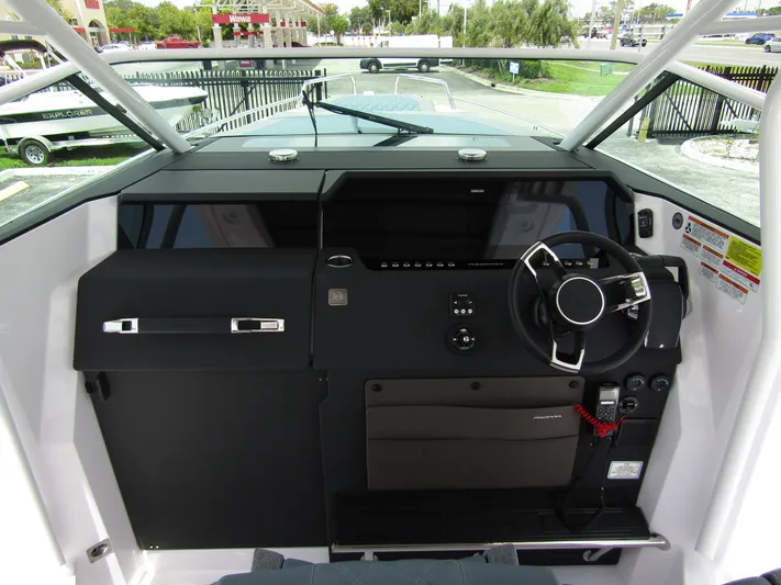  Yacht Photos Pics 2024 Axopar 37 Sun Top helm with modern steering and dashboard controls.