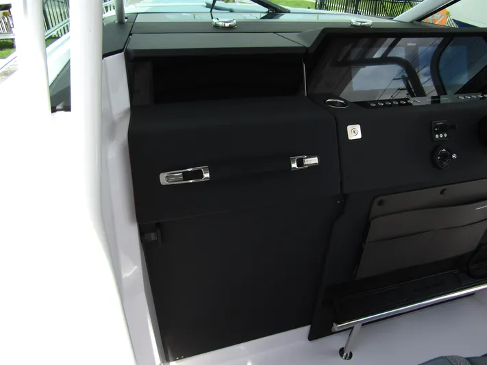  Yacht Photos Pics 2024 Axopar 37 Sun Top interior dashboard with sleek black design and modern controls.