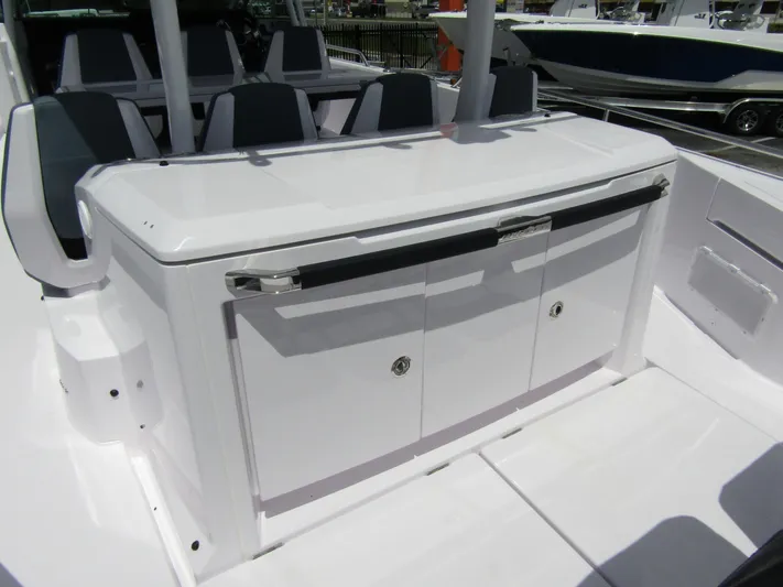  Yacht Photos Pics 2024 Axopar 37 Sun Top boat interior with sleek white cabinetry and seating.