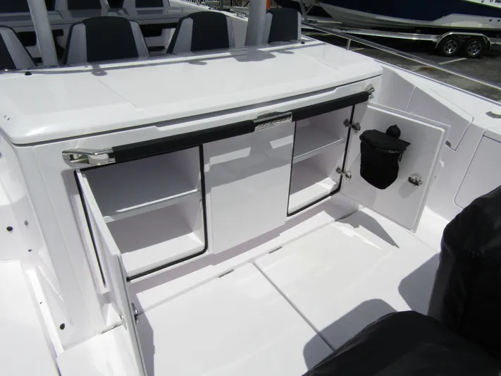  Yacht Photos Pics 2024 Axopar 37 Sun Top interior storage compartments on deck.