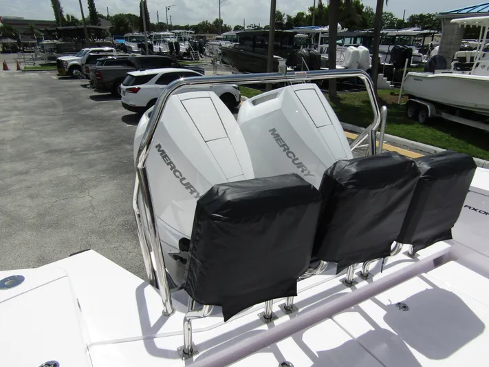  Yacht Photos Pics 2024 Axopar 37 Sun Top with dual Mercury engines in a marina setting.