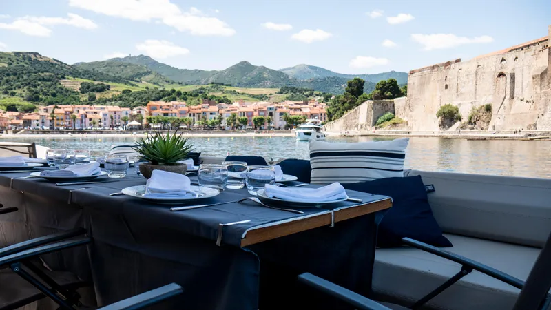  Yacht Photos Pics Luxurious dining setup on a 2016 Ferretti Yachts 550 with scenic waterfront view.