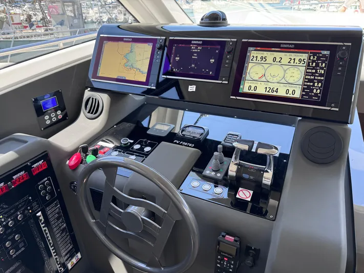  Yacht Photos Pics Helm of 2016 Ferretti Yachts 550 with navigation screens and controls.