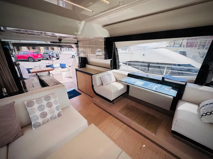  Yacht Photos Pics Luxurious interior of 2016 Ferretti Yachts 550 with modern seating and large windows.
